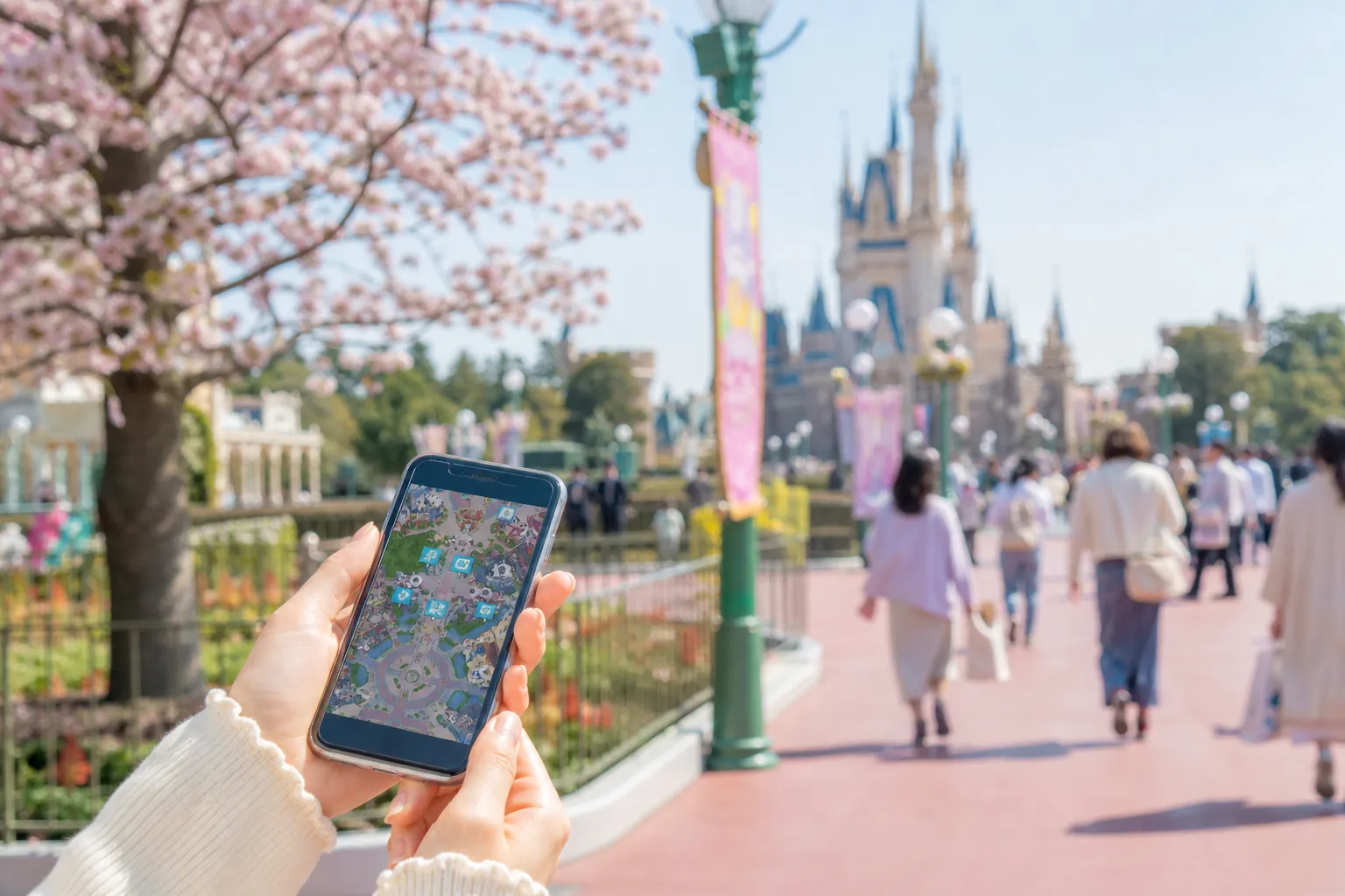 Visitor using the Tokyo Disney Resort App to manage attraction access at Fantasy Springs