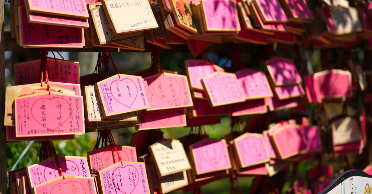Traditional Japanese coated beans displayed in wooden boxes at a Kamakura shop