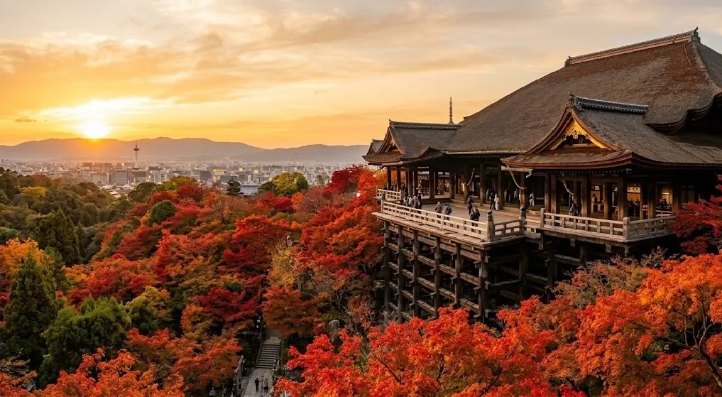 A dramatic view of Kiyomizu-dera's expansive wooden stage jutting out from a steep hillside, beautifully surrounded by vibrant crimson and gold autumn maple trees under a soft golden sky.